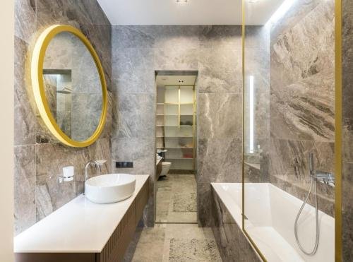 Bathroom interior with sink on counter near mirror and bath